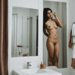 An Indian girl displaying confidence and grace in her bathroom mirror reflection, capturing her journey.